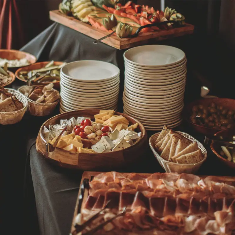 A gourmet buffet setup with cheese, fruits, and cold cuts, symbolizing Artmedia Digital's rich and diverse web design and branding palette.