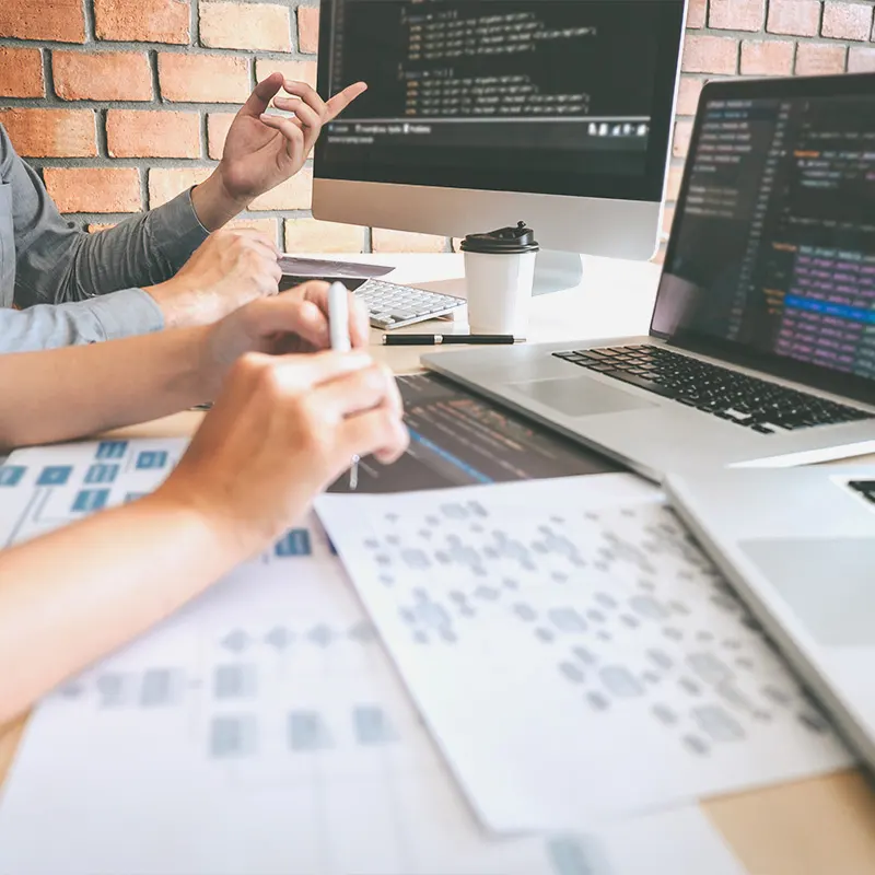 Collaborative web development and coding session with developers working on complex programming, showcasing Artmedia Digital's expertise in building dynamic websites.
