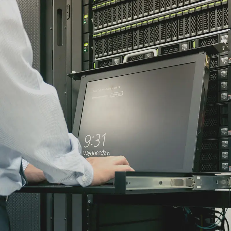 Secure web hosting services infrastructure managed by an Artmedia Digital technician working on a server rack, ensuring reliable and high-performance website uptime.