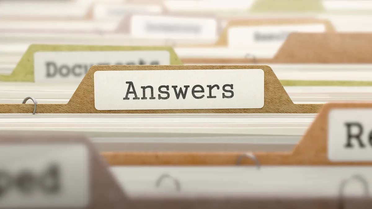 File folder tab labeled “Answers” in an index-card drawer, symbolizing Answer Engine Readiness for AI Overviews (AEO).